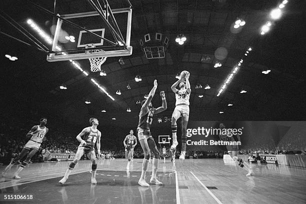 Milwaukee, WI- Milwaukee Bucks' Lew Alcindor shoots for two points over L.A. Lakers' Wilt Chamberlain during the Lakers-Bucks playoff game, April 11....