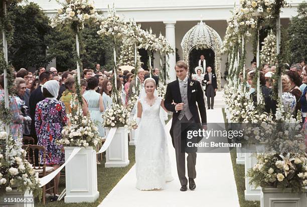 Washington, DC.: After taking their vows, Edward Finch Cox and Tricia Nixon Cox walk through rows of flowers past their guests en route to the White...