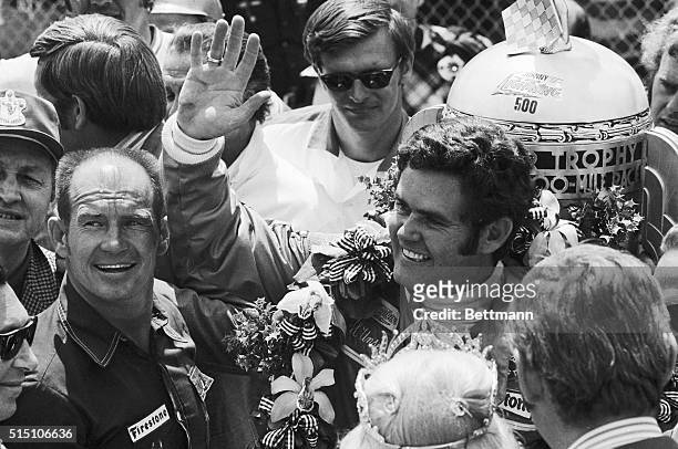 Parnelli Jones , 1963 Indy winner, with Al Unser, of Albuquerque, New Mexico, as Unser acknowledges cheers from crowd after winning the Indianapolis...