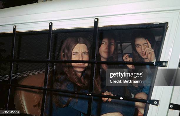 Los Angeles, California: The three female members of Charles Manson's "family" ham it up for photographers through the window of the sheriff's van as...