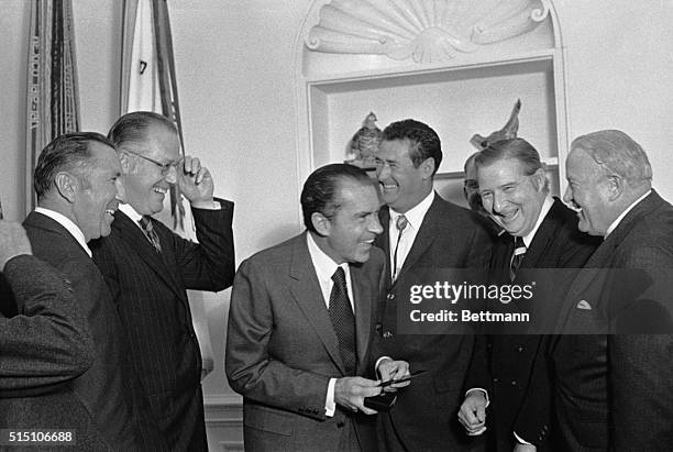 Officials of the American and National Leagues called on President Nixon at the White House here and presented him with season passes. Left to right...