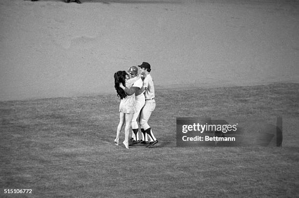 The mystery girl who ran out from the stands at Doger Stadium chass Dodgers Wes Parker around the field as Astros Doug Radar joined in by restraining...