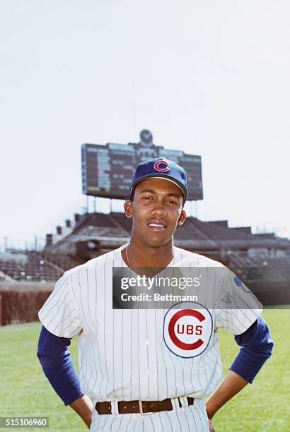 Fergie Jenkins of the Chicago Cubs baseball team is shown in uniform, from the waist up, on a baseball field.