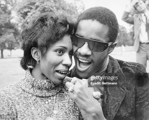 Blind singing star Stevie Wonder walks with his fiancee Syreeta Wright, a singer and lyricist, in Hyde Park here after announcing their engagement...