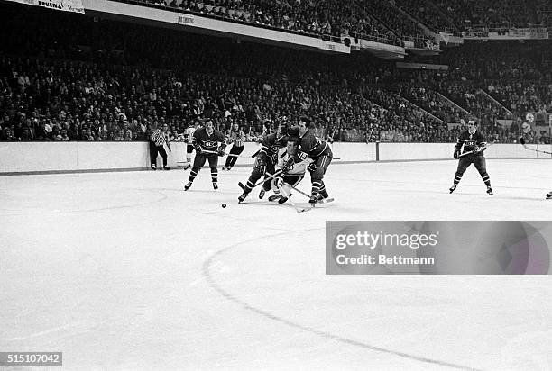 Bobby Orr of the Boston Bruins, tries to split the Montreal defense and is taken to the ice by Canadiens' Jacques LaPerriere and Terry Harper ....