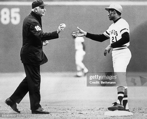 Roberto Clemente made his 3,000 hit. Doug Harvey, umpire, is shown handing him the ball on the field.
