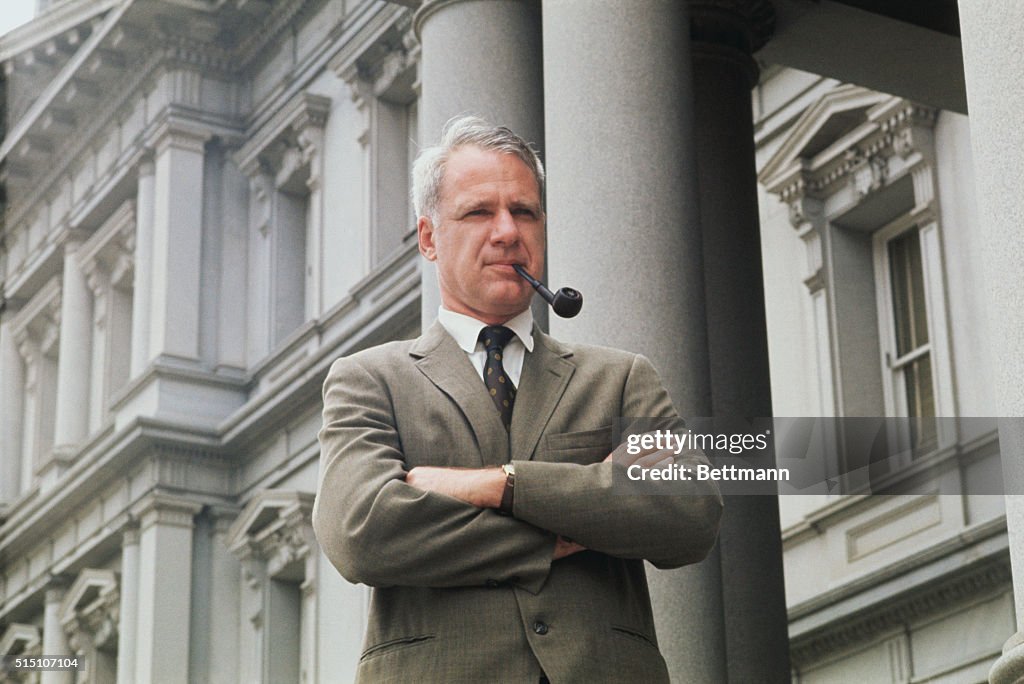 James Schlesinger Smoking a Pipe