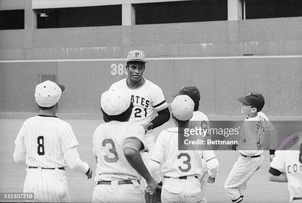 Group of youngsters from Puerto Rico flock to Pirates star Roberto Clemente during the filming of a commercial at Three Rivers Stadium.