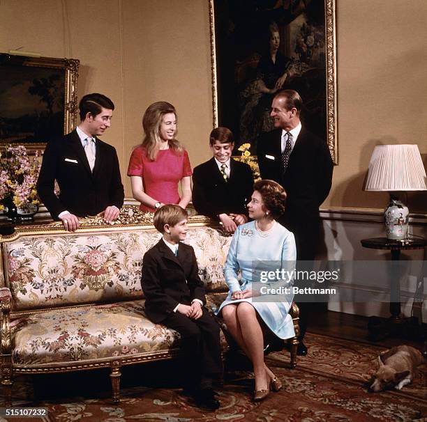 London, England: Queen Elizabeth and Prince Philip with their four children, Prince Charles, Princess Anne, Prince Andrew, and Prince Edward, seated...