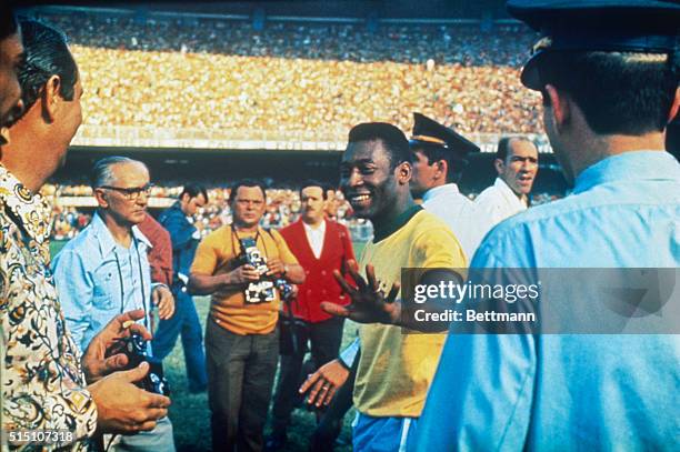 Pele is shown with photographers and reporters at Mercana Stadium. He played his last international game on this day, choosing to leave the sport at...