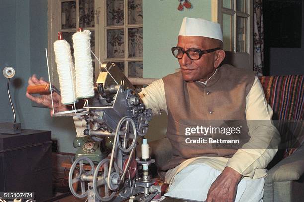 New Delhi, India: Once the Deputy Prime Minister of India and now a bitter critic of Mrs. Gandhi, Morarji Desai. He is shown spinning yarn at home.