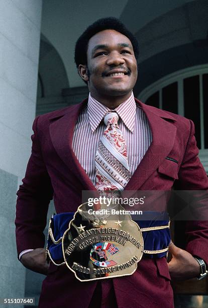 Heavyweight champion thanks to a knockout of Joe Frazier in Kingston, Jamaica, 1/22, George Foreman sports his championship belt.