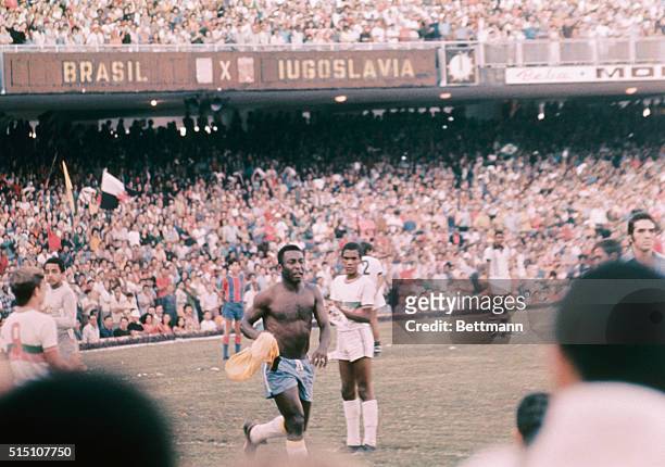 Pele, playing his last international game, runs "lap of honor" around Mercana Stadium here at half-time in a game with Yugoslavia. He stripped off...