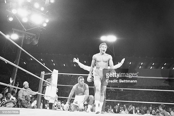 Challenger George Foreman walks away from champion Joe Frazier as he wins the world heavyweight championship in Kingston, Jamaica, January 22, 1973....