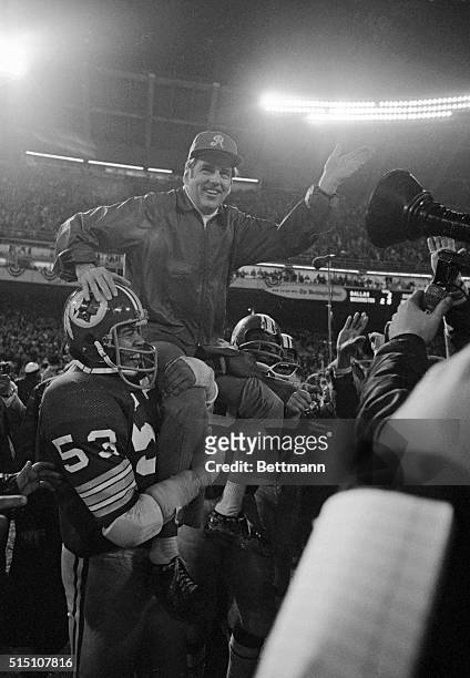 Jubilant Redskin coach George Allen is carried from the field by linebacker Harold McLinton following the 'Skins 26-3 victory over the Dallas Cowboys...