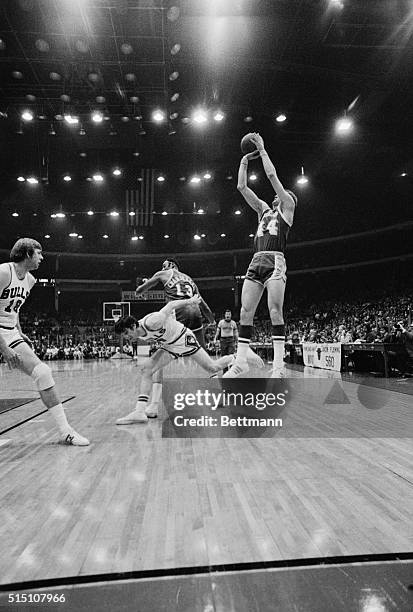 Chicago: Chicago Bulls' Jerry Sloan brushes past Lakers' Wilt Chamberlain as he charges in attempting to break up shot by Jerry West during first...