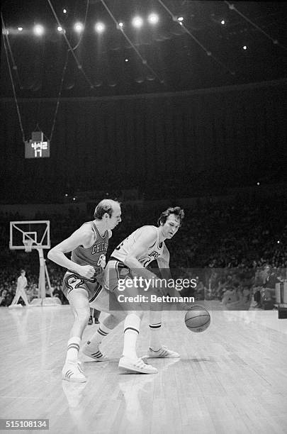 Inglewood, Calif.: Bob Weiss of the Chicago Bulls seems a bit surprised as Los Angeles Lakers Jerry West uses fancy footwork to get by during play....