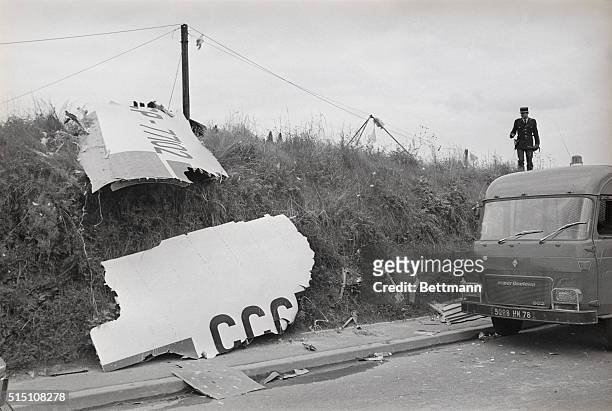 Piece of the wing of the Soviet supersonic Tupolev 144 Jet, bearing the letters "CCCP," lie at the edge of a field in suburban Goussainville, after...