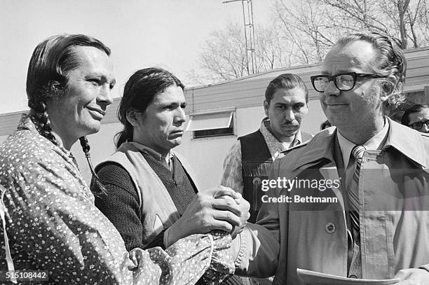 Wounded Knee, S.D.: American Indian Movement Leaders, Russell Means, Dennis Banks and Carter Camp join hands with James Armstrong, Bishop of the...