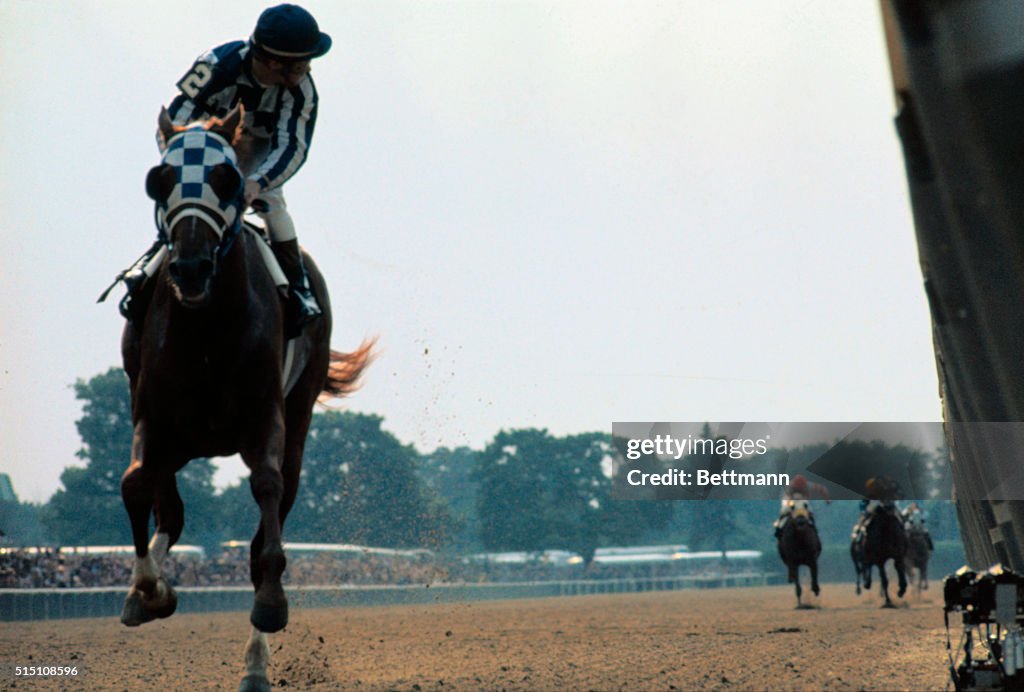 The field is so far behind, jockey Ron Turcotte has to turn in the ...