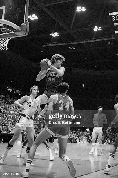 Westwood, Calif.: Red-haired Bill Walton, the reigning king of college basketball goes high into the air to bring down a rebound during play against...