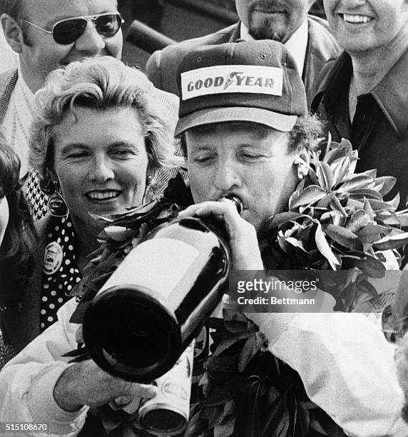 Foyt, winner of the Pocono 500, drinks champagne in Victory Lane. His average speed was 144.944, with a king-size number of pit stops before a crowd...