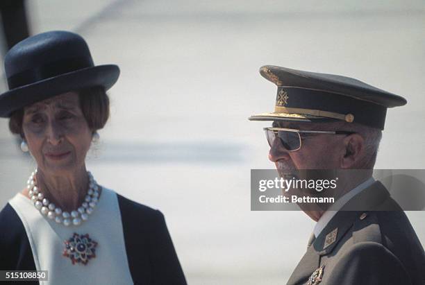 Spanish Chief of State Generalissimo Francisco Franco, with spouse, in uniform wearing hat during ceremony. | Location: Madrid, Spain.