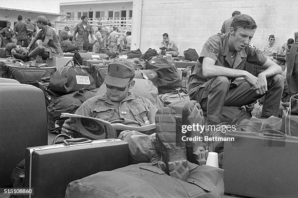 It's all over...American soldiers relax with their baggage at Camp Alpha, march 28th, as they await departure en route back to the U.S. The last...