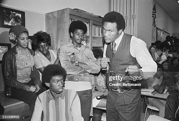 Berkeley, Calif.: World heavyweight champion George Foreman sports his championship belt during visit to Berkeley High School fulfilling a promise to...