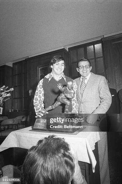 John Cappelletti , Penn State's tailback, joins with his coach, Joe Paterno, as they look at the Heisman Trophy won by Cappelletti 12/4. The big,...