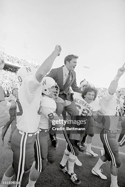 Dallas; Nebraska Cornhuskers Mike Offner and John Bell ( carry coach Tom Osborne off the field after they defeated the Texas Longhorns 19-3 in the...
