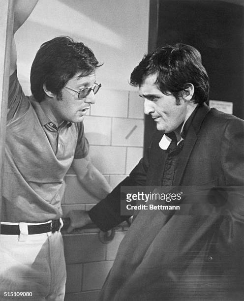 Director, William Friedkin , discusses a scene with playwright-actor, Jason Miller, on set of the movie "The Exorcist".