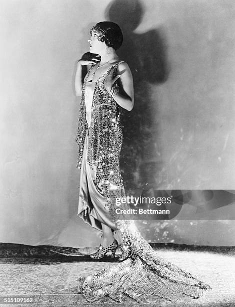 The Glorious Gloria in a Glorious Gown. And now they are making dresses out of steel. Miss Gloria Swanson proves it. The plate from scrapped...