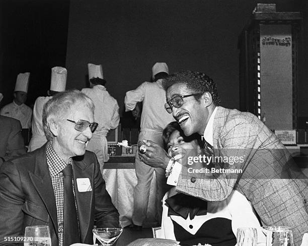 Reno, Nevada: Sammy Davis Jr. Offers cake to Bill Harrah, from an exact replica of Harrah's 250-room, $27 million hotel-casino. Davis acted as a...