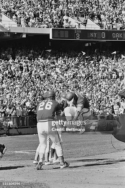 Oakland, Calif.: Oakland A's Reggie Jackson jumps high as he crosses home plate after hitting a home run deep into the right centerfield stands,...