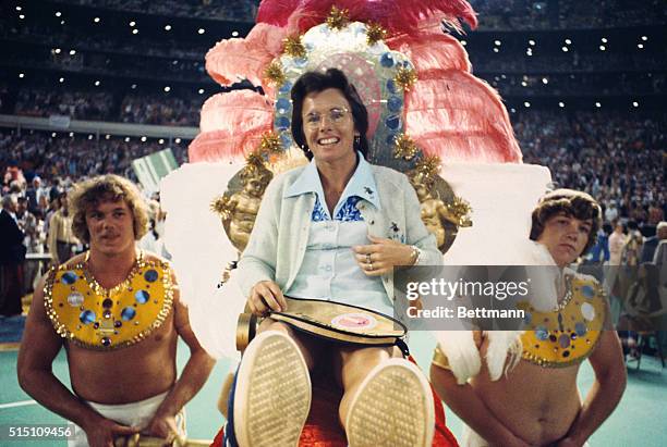 Tennis star Billie Jean King is carried to the court by four men for the battle of the sexes tennis match with 55-year-old aging tennis star Bobby...