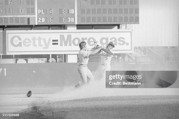 Pete Rose and Bud Harrelson of the New York Mets start a fight that turned into a bench-clearing brawl during the National League playoffs of 1973.