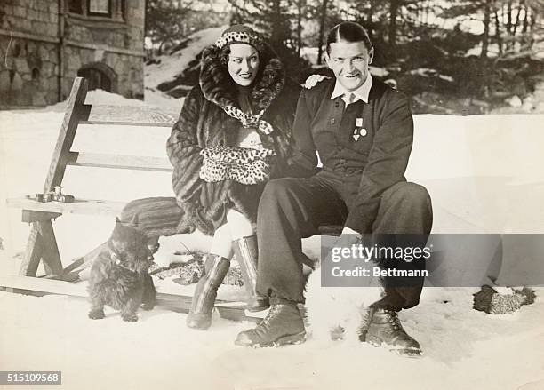 St. Moritz, Switzerland-ORIGINAL CAPTION READS: The Michael Farmers shown as they enjoying winter sports.