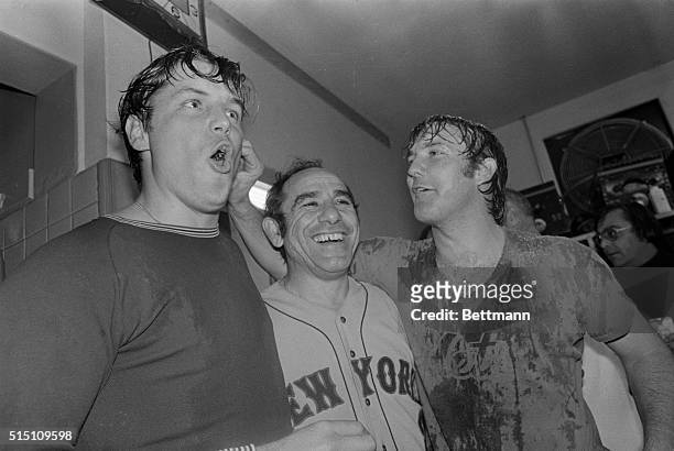 Winning pitcher Tom Seaver, manager Yogi Berra, , and relief pitcher Tug McGraw, enjoy celebration in the Mets dressing room here, after winning the...
