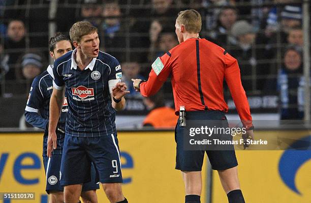 Fabian Klos of Bielefeld argues with referee Martin Petersen during the Second Bundesliga match between Arminia Bielefeld and 1. FC Nuernberg at...