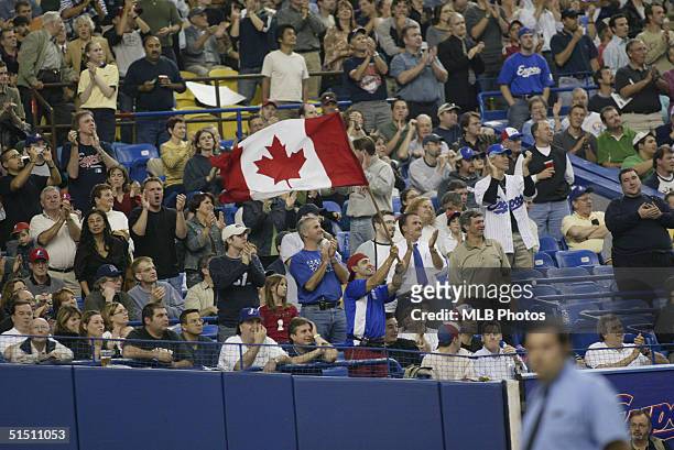 Montreal Expos fan waves a Canadien Flag during the final Expos home game ever at Olympic Stadium against the Florida Marlins on September 29, 2004...
