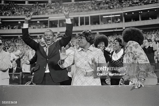 Hank Aaron's parents, Herbert and Estella, yell for joy after seeing their son hit his 713th career home run in the fifth inning of the Braves game...