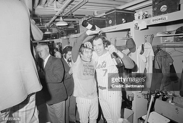 Reliever Tug McGraw and Ed Kranepool celebrate with champagne after Mets beat Reds 7-2, to clinch National League pennant.