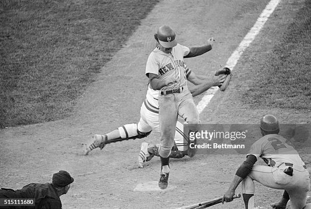 New York Mets Bud Harrelson crosses home plate in a close play here, as Oakland A's catcher Ray Fosse reaches for him. Home plate umpire Augie...