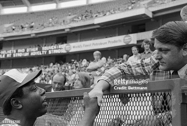 Braves star Hank Aaron shaking hands with former New York Yankee slugger Roger Maris prior to the Mets-Braves game in Atlanta. Maris set a Major...