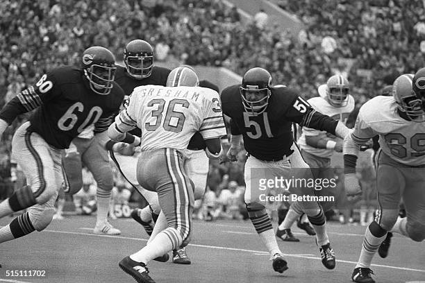Bob Gresham is faced with an impregnable wall in the persons of Chicago Bears' Wally Chambers , Mel Tom and super-stop Dick Butkus as he is stopped...
