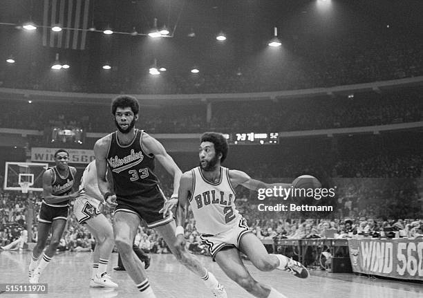 Bulls guard Norm Van Lier drives past Bucks center Kareem Abdul-Jabbar during Game 2 of the NBA Playoffs at the United Center in Chicago....