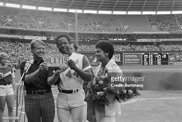 Hank Aaron is honored during a pregame awards ceremony at Atlanta-Fulton County Stadium, celebrating his record-breaking 715th home run which broke...