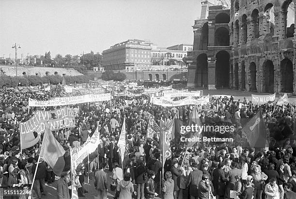 Rome, Italy: Workers with red flags and banners demonstrate at the Colosseum during a general strike in protest against inflation and unemployment....