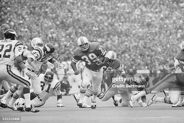 Houston, TX-ORIGINAL CAPTION READS: The Dolphins' offensive star of Super Bowl VIII, Larry Csonka, slides through the line for a short gain 1/13 as...